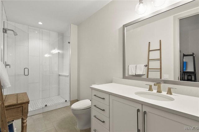 bathroom featuring walk in shower, vanity, toilet, and tile patterned flooring