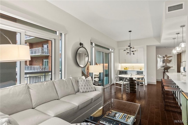 living room featuring dark hardwood / wood-style floors and a notable chandelier