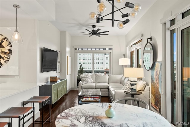 living room featuring dark wood-type flooring and ceiling fan