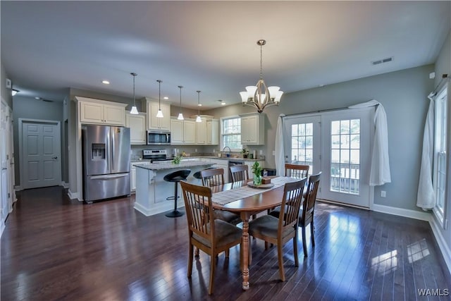 4401 Nicholas Ave, Northport, AL 35473 - dining room with baseboards, dark wood-style flooring, a chandelier, and recessed lighting