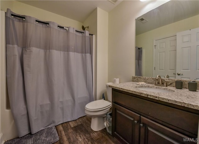 4401 Nicholas Ave, Northport, AL 35473 - bathroom with wood finished floors, vanity, toilet, and a shower with shower curtain