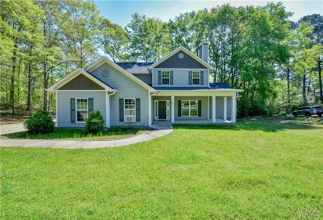 4401 Nicholas Ave, Northport, AL 35473 - view of front facade with a chimney, a front lawn, and covered porch