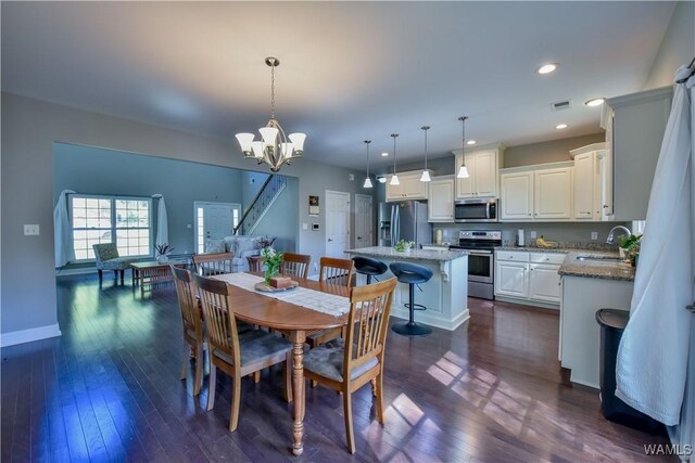 4401 Nicholas Ave, Northport, AL 35473 - dining space with a chandelier, dark wood-type flooring, baseboards, and recessed lighting
