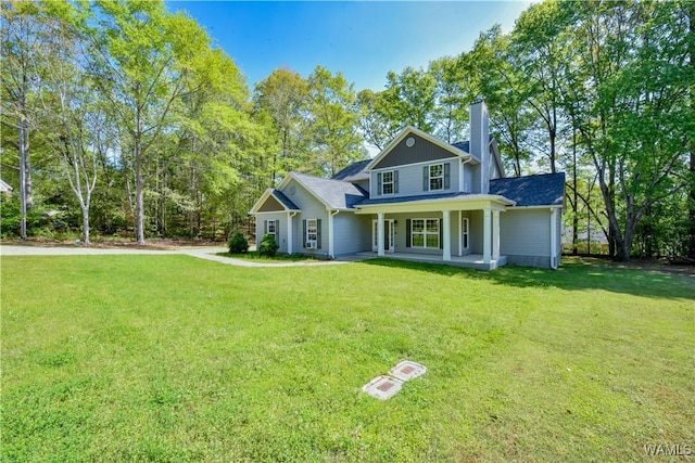4401 Nicholas Ave, Northport, AL 35473 - traditional home featuring a chimney, a porch, and a front yard