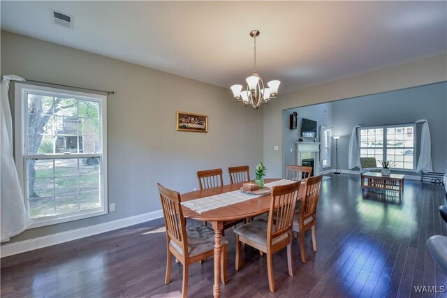 4401 Nicholas Ave, Northport, AL 35473 - dining area featuring a chandelier, wood-type flooring, plenty of natural light, and baseboards