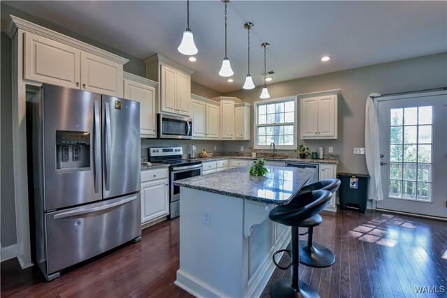 4401 Nicholas Ave, Northport, AL 35473 - kitchen with stainless steel appliances, white cabinetry, a kitchen island, light stone counters, and recessed lighting