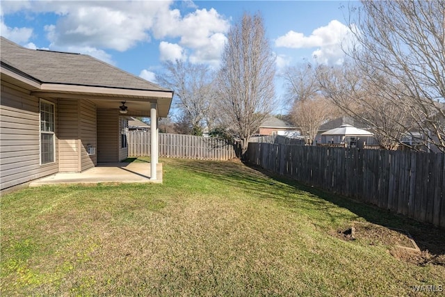 view of yard with a patio and ceiling fan