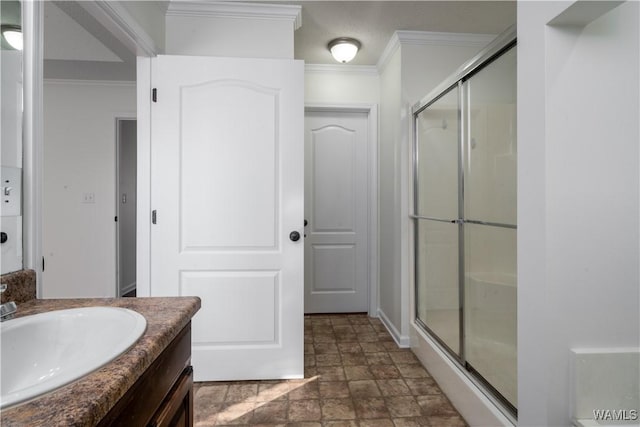 bathroom with vanity, an enclosed shower, and crown molding