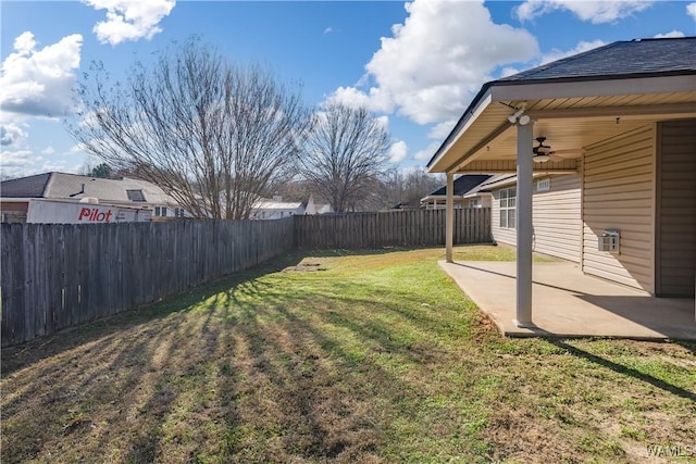 view of yard with ceiling fan and a patio