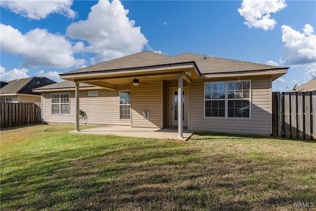 back of house featuring a yard and a patio