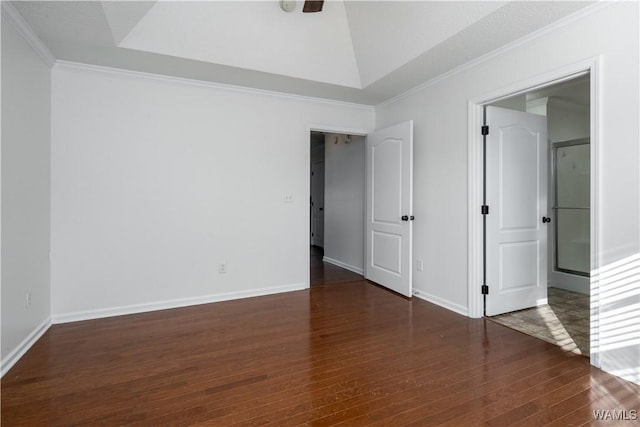 unfurnished room featuring dark hardwood / wood-style floors, ornamental molding, and a tray ceiling