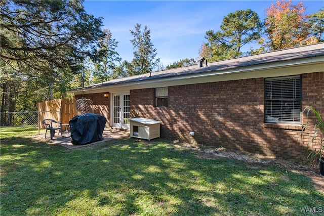 rear view of house with a yard