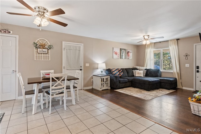 living room featuring light wood-type flooring and ceiling fan