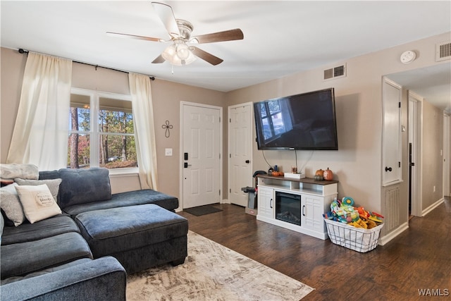 living room with dark hardwood / wood-style floors and ceiling fan