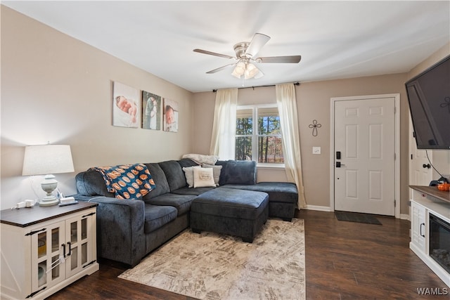 living room featuring dark hardwood / wood-style flooring and ceiling fan