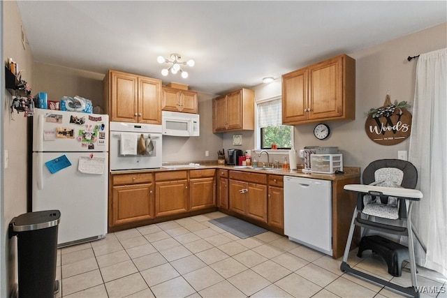 kitchen with white appliances, sink, and light tile patterned floors