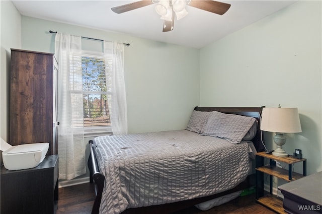 bedroom with dark hardwood / wood-style floors and ceiling fan