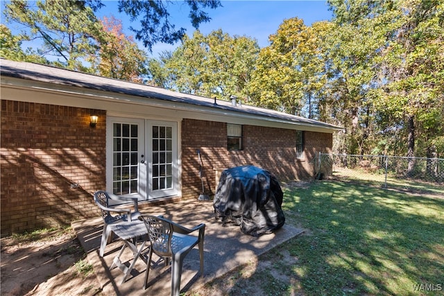 exterior space featuring french doors and a grill