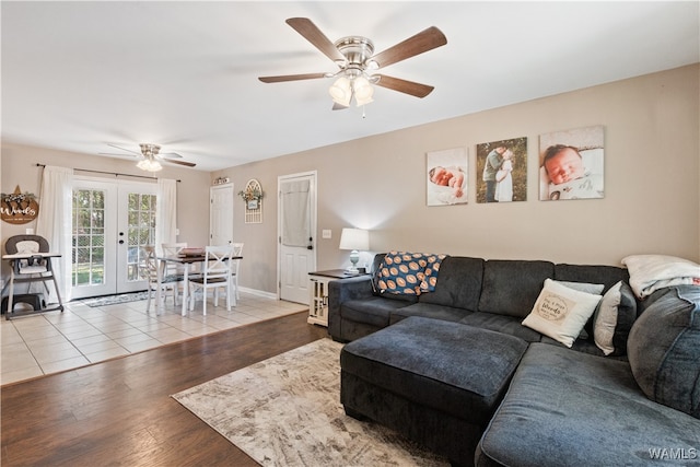 living room with ceiling fan, french doors, and light hardwood / wood-style flooring