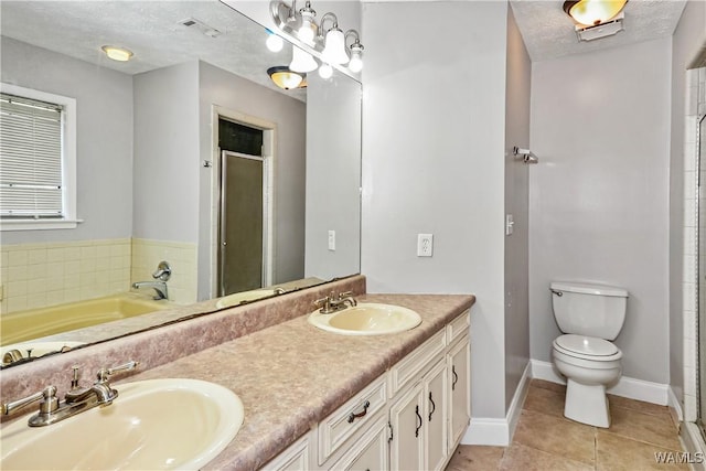 1924 Still Oaks Dr, Montgomery, AL 36117 - full bathroom with double vanity, a shower stall, a garden tub, tile patterned floors, and a textured ceiling