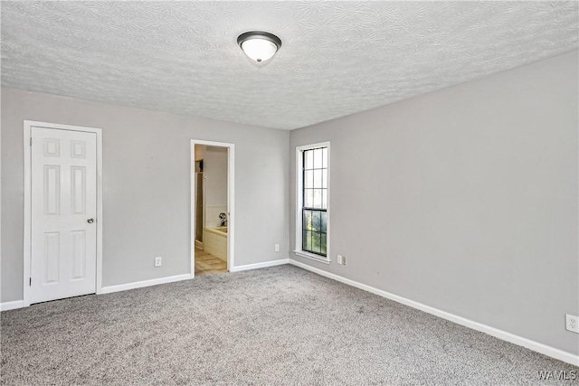 1924 Still Oaks Dr, Montgomery, AL 36117 - unfurnished bedroom with a textured ceiling, carpet, and ensuite bathroom