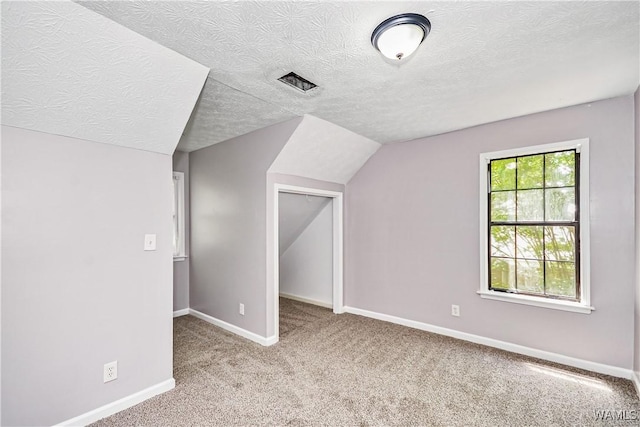 1924 Still Oaks Dr, Montgomery, AL 36117 - bonus room featuring a textured ceiling, carpet flooring, and vaulted ceiling