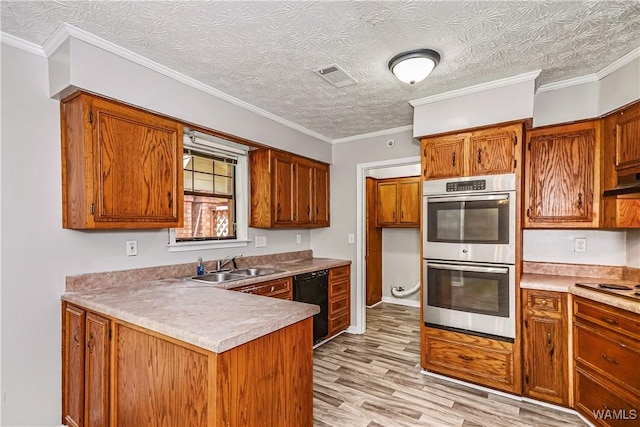 1924 Still Oaks Dr, Montgomery, AL 36117 - kitchen with stainless steel double oven, black dishwasher, brown cabinets, a peninsula, and light wood-style floors