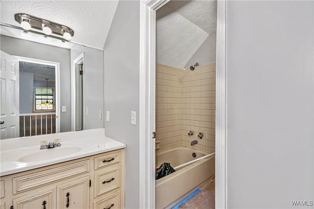 1924 Still Oaks Dr, Montgomery, AL 36117 - bathroom with vanity,  shower combination, a textured ceiling, vaulted ceiling, and tile patterned floors