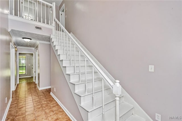 1924 Still Oaks Dr, Montgomery, AL 36117 - stairs with crown molding and tile patterned flooring