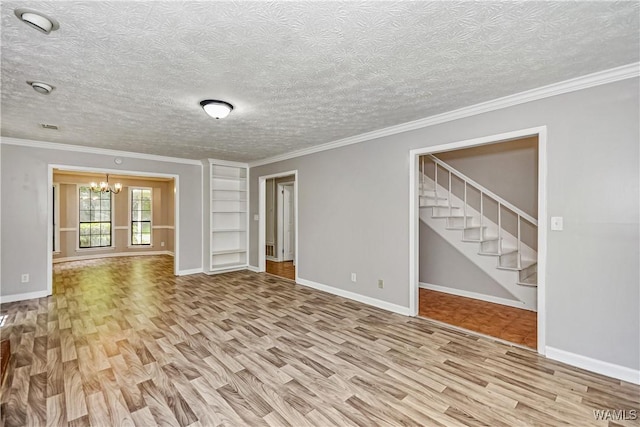1924 Still Oaks Dr, Montgomery, AL 36117 - unfurnished living room featuring wood finished floors, a chandelier, stairs, crown molding, and a textured ceiling