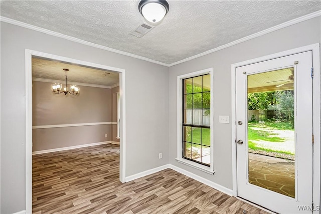 1924 Still Oaks Dr, Montgomery, AL 36117 - doorway featuring wood finished floors, a chandelier, and crown molding