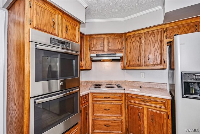 1924 Still Oaks Dr, Montgomery, AL 36117 - kitchen featuring stainless steel appliances, brown cabinetry, light countertops, and crown molding