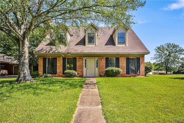 1924 Still Oaks Dr, Montgomery, AL 36117 - new england style home with a front yard, roof with shingles, and brick siding