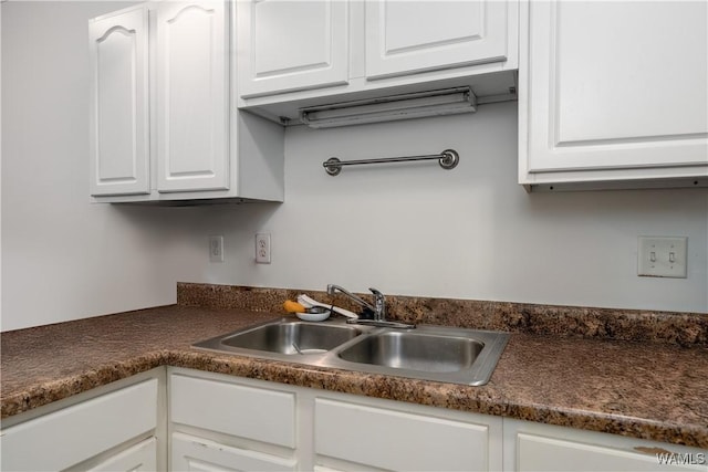 303 Helen Keller Blvd Unit A111, Tuscaloosa, AL 35404 - kitchen with dark countertops and white cabinets
