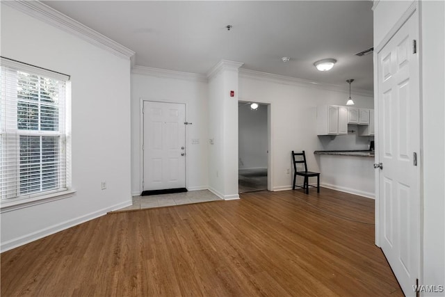 303 Helen Keller Blvd Unit A111, Tuscaloosa, AL 35404 - unfurnished living room with wood finished floors and crown molding