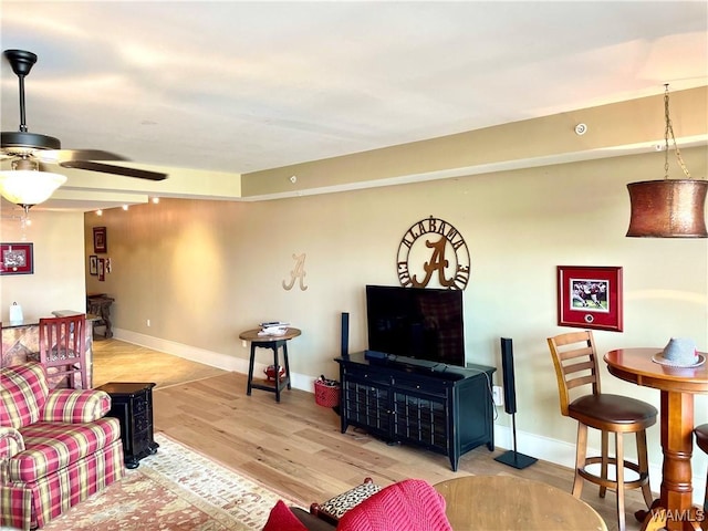 living room with ceiling fan and light wood-type flooring