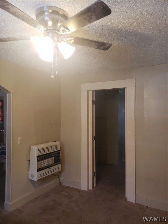 interior space featuring a textured ceiling, heating unit, and ceiling fan