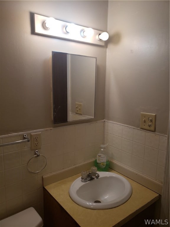 bathroom featuring vanity, tile walls, and backsplash