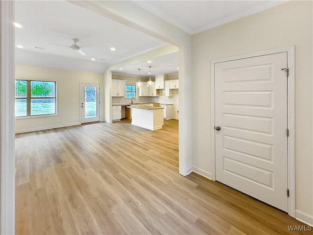 13879 Gilliam Rd, Berry, AL 35546 - unfurnished living room featuring a ceiling fan, light wood-style floors, baseboards, crown molding, and recessed lighting