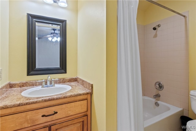 full bathroom with vanity, ceiling fan, toilet, and shower / tub combo with curtain