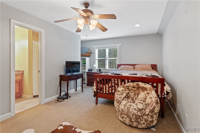 carpeted bedroom featuring ceiling fan, lofted ceiling, and ensuite bathroom