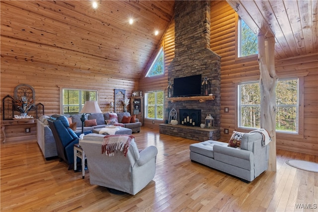 living room with light hardwood / wood-style flooring, high vaulted ceiling, plenty of natural light, and wooden ceiling