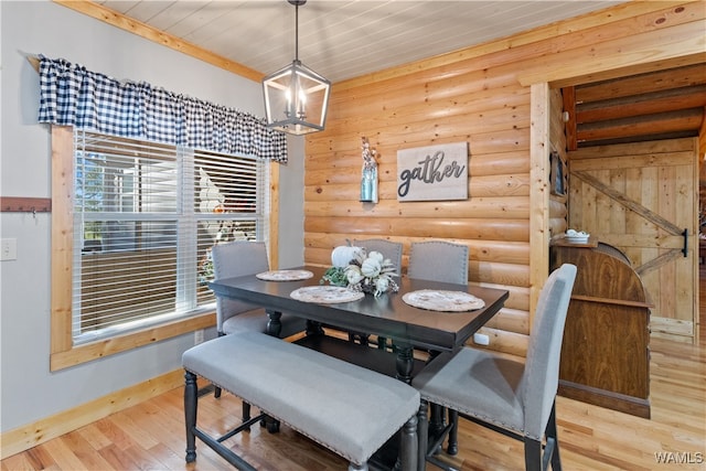 dining area featuring wood ceiling, a barn door, light wood-type flooring, and log walls