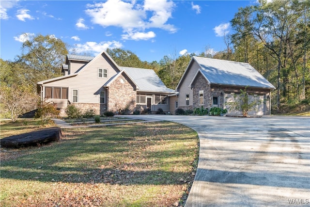 view of front of home featuring a garage and a front lawn