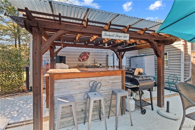 view of patio featuring an outdoor bar