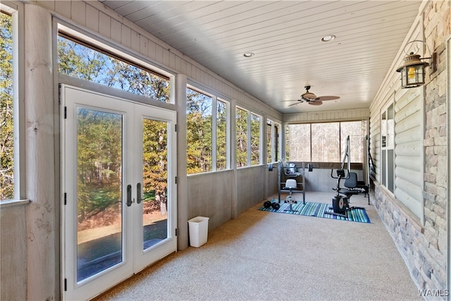 sunroom / solarium with plenty of natural light, ceiling fan, and french doors