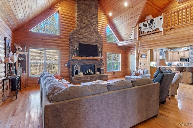 living room with wood ceiling, high vaulted ceiling, and light hardwood / wood-style floors