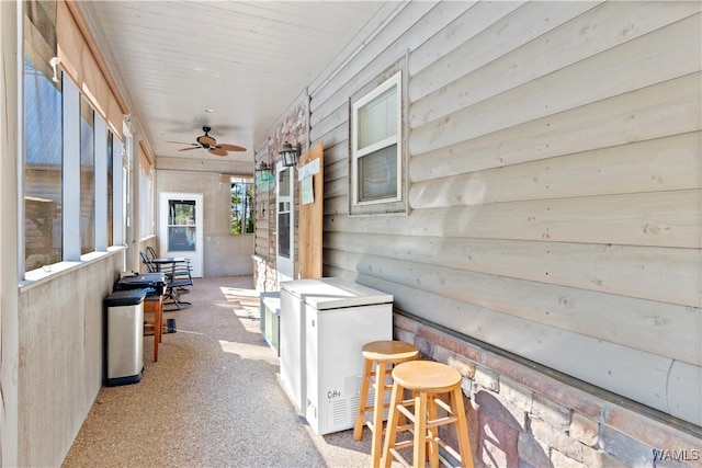 sunroom featuring ceiling fan