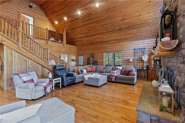 living room with a fireplace, hardwood / wood-style floors, high vaulted ceiling, and wood ceiling