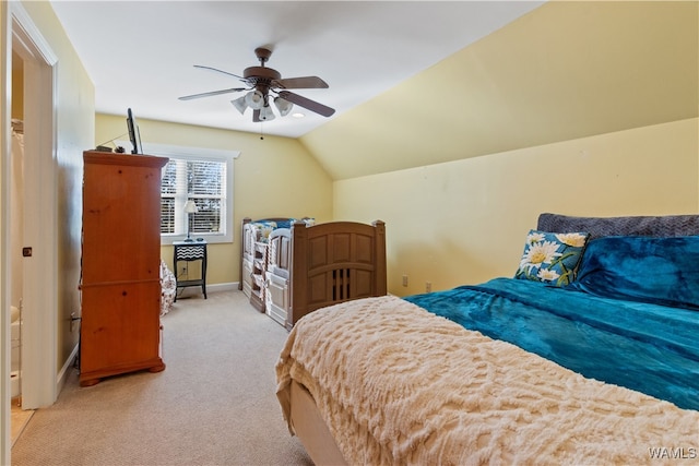 bedroom with ceiling fan, light colored carpet, and vaulted ceiling